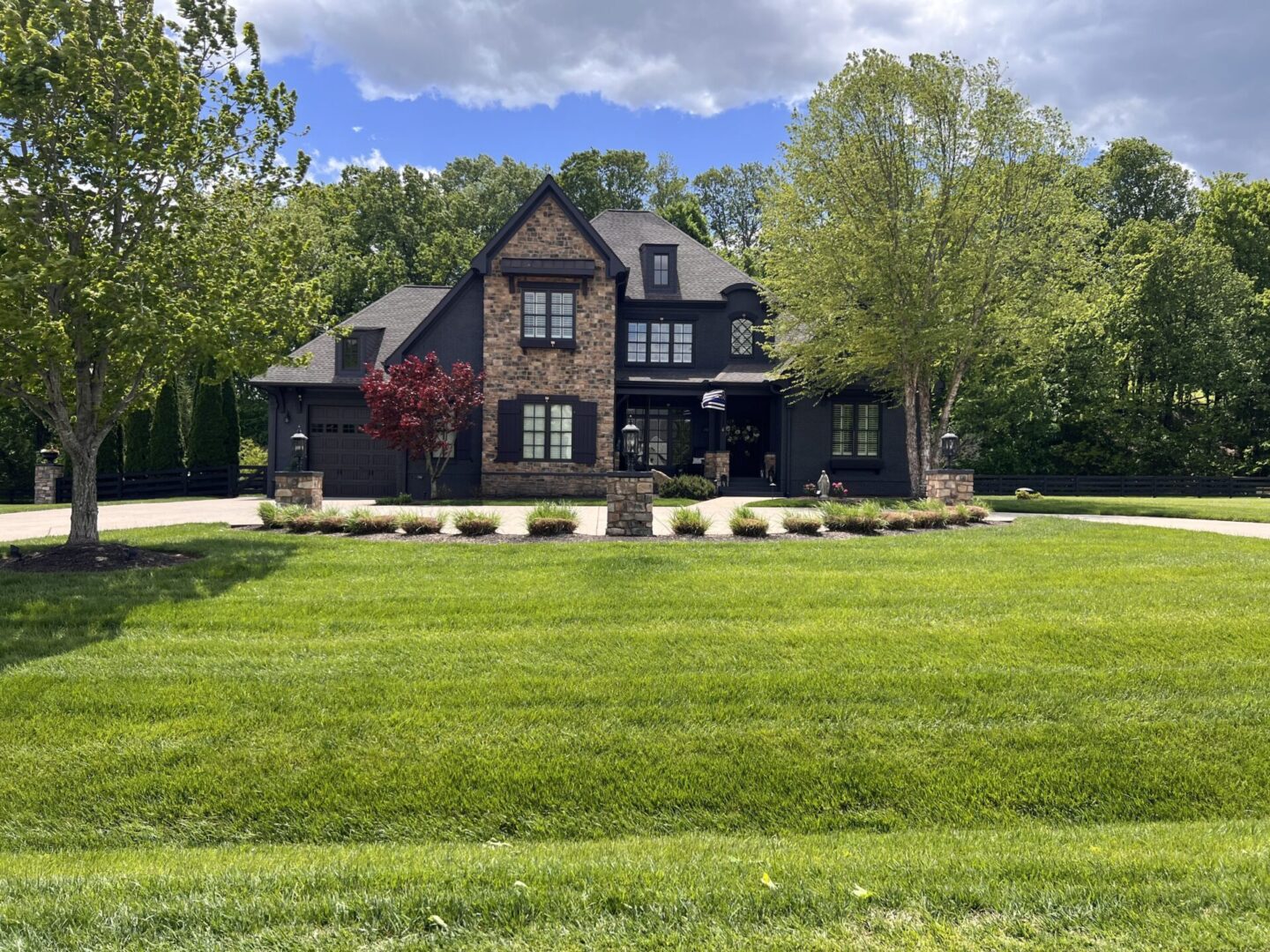 A large house with a lawn in front of it.